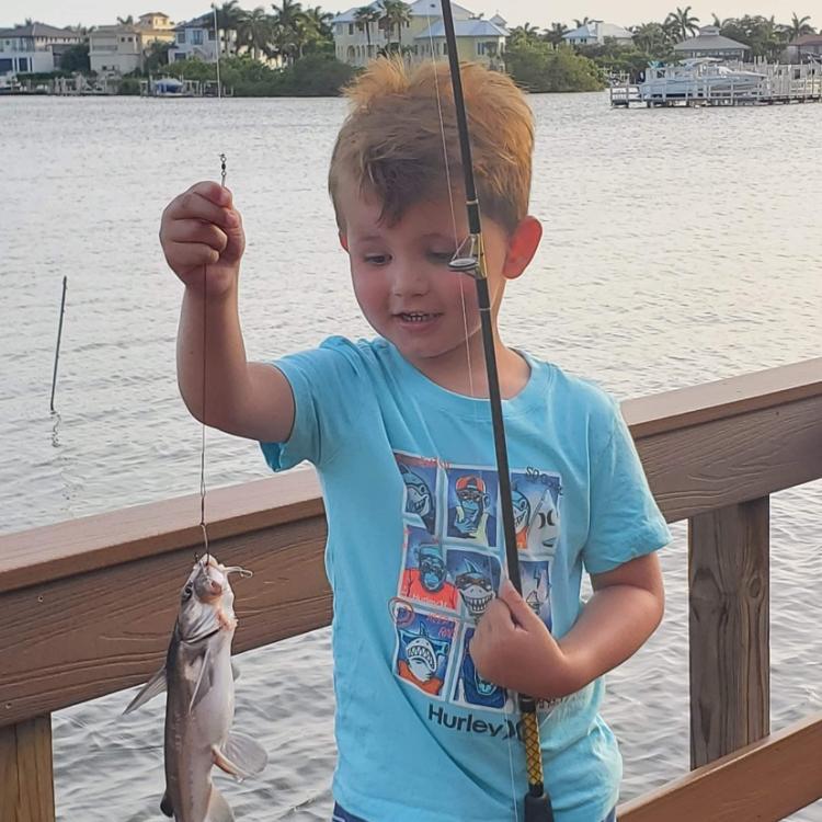 Little boy holding a fish