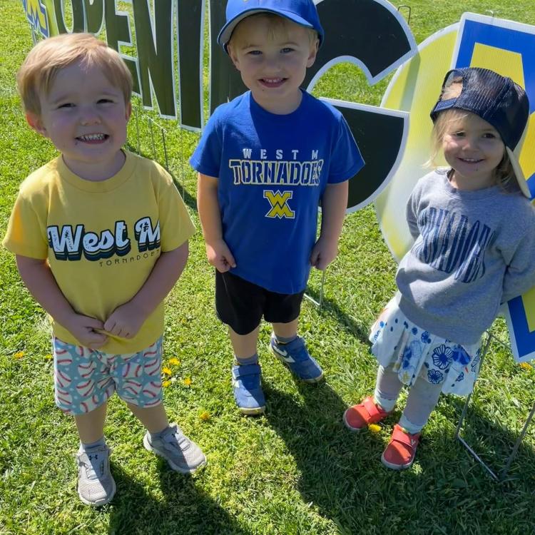 three smiling small children