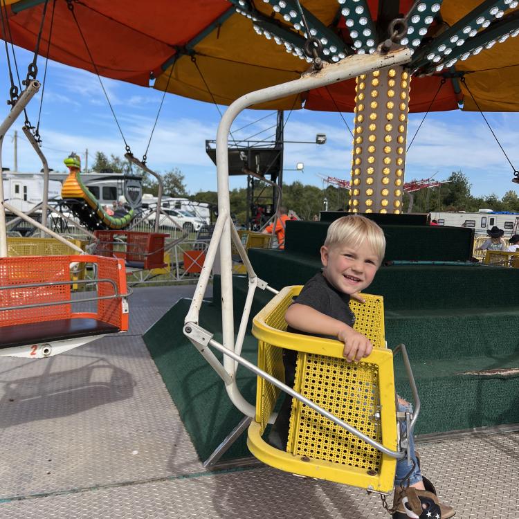 little boy on carnival ride