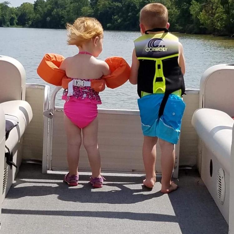 small boy and girl on boat deck