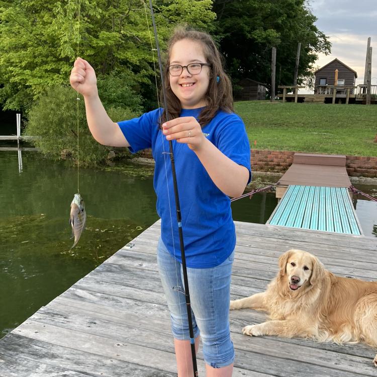 girl smiling holding fish