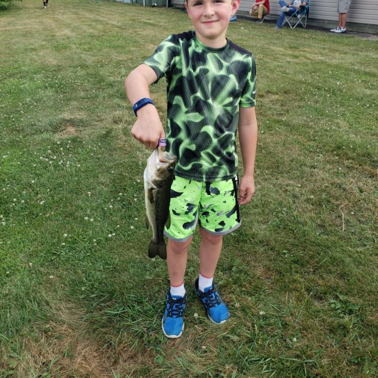 boy smiling holding a fish