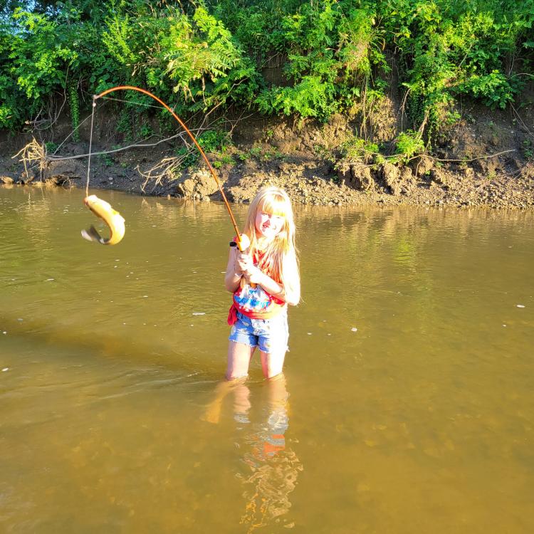 girl smiling holding fish