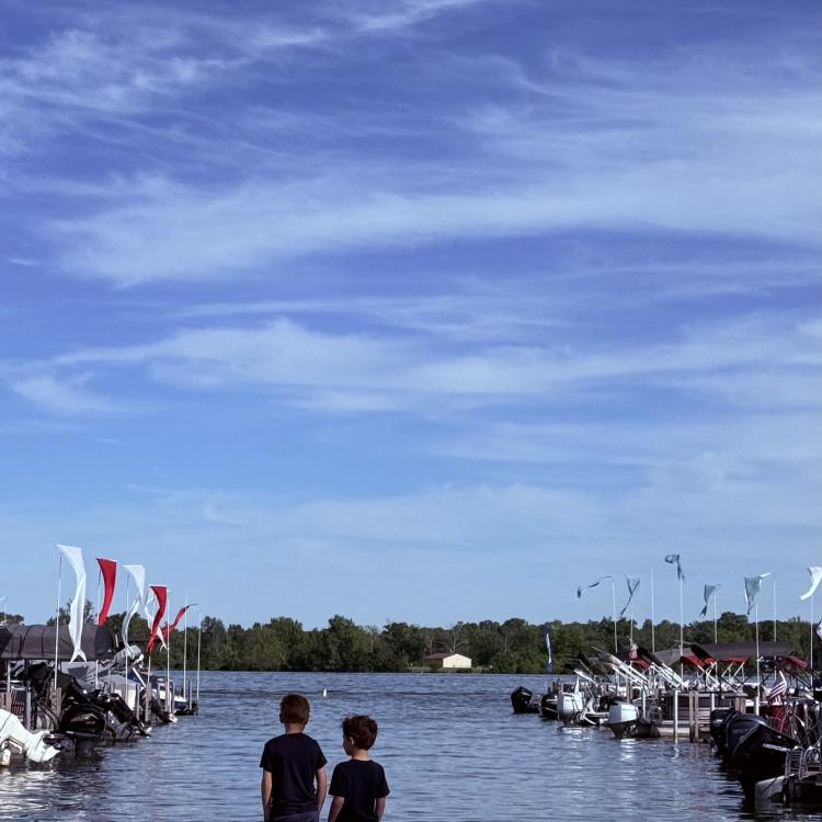 two boys at edge of lake