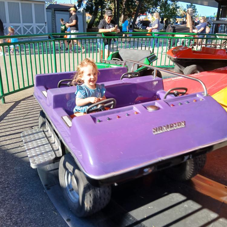 little girl on kids' coaster