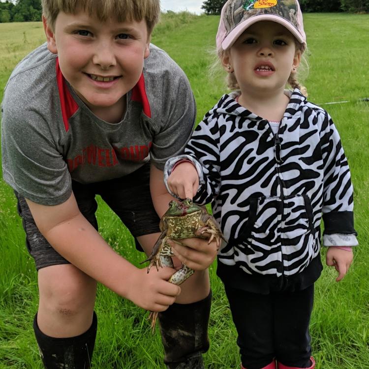 little boy and girl holding a fish