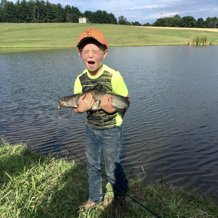 boy holding a fish