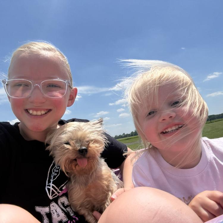 two little girls with a small dog