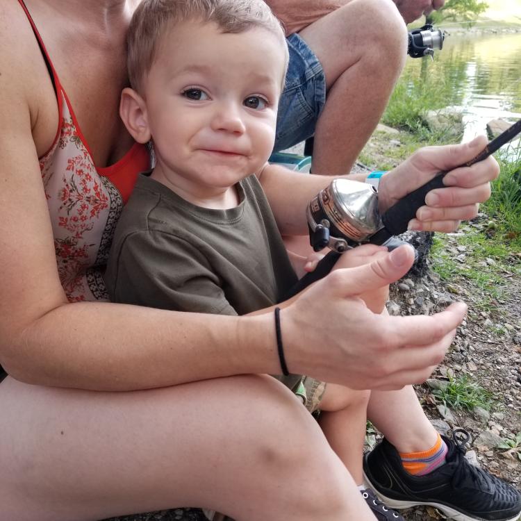 Little boy smiling while fishing