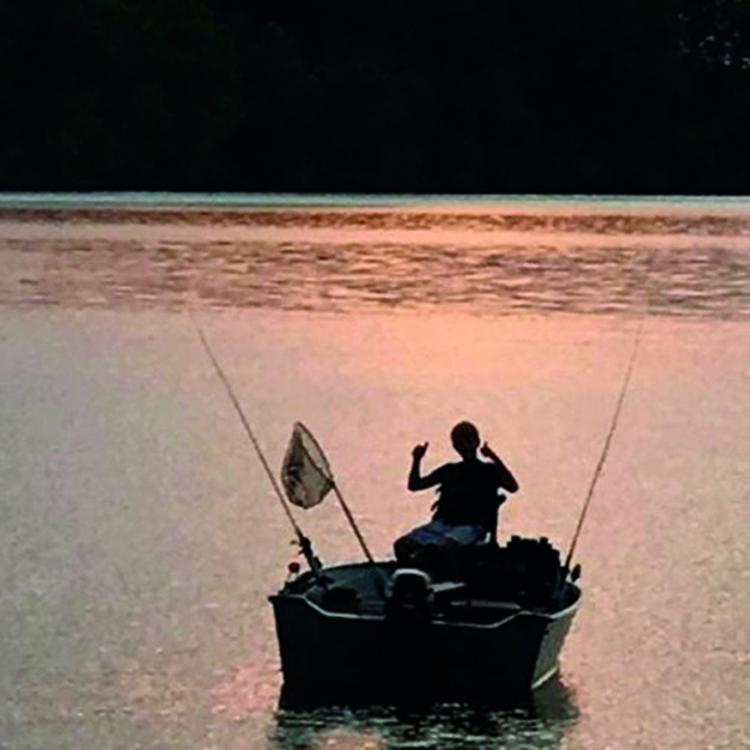 person fishing in a boat