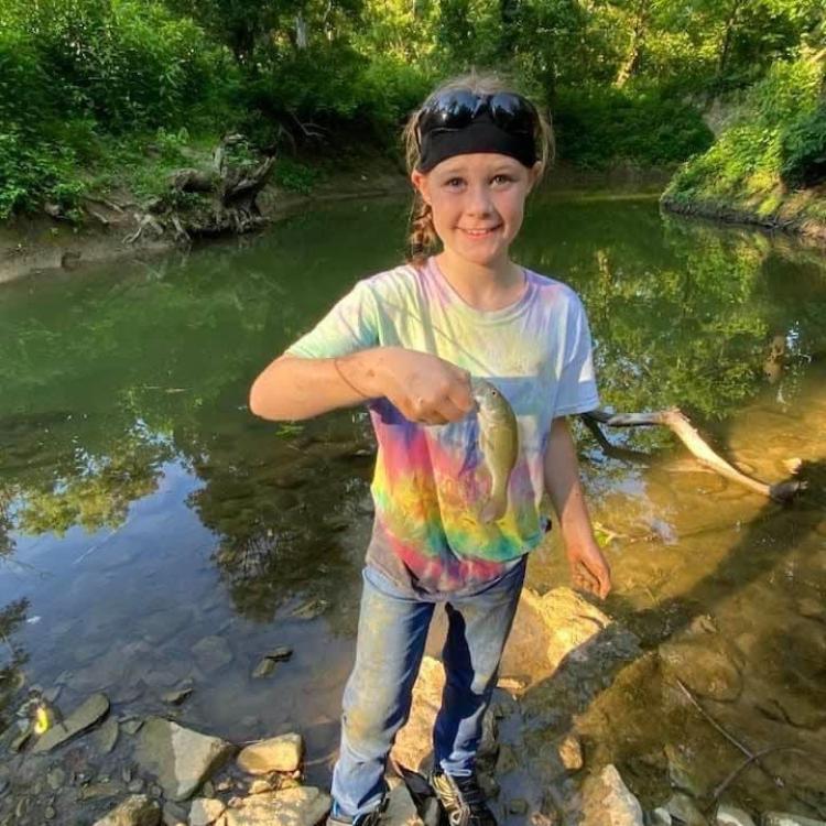 girl smiling holding fish