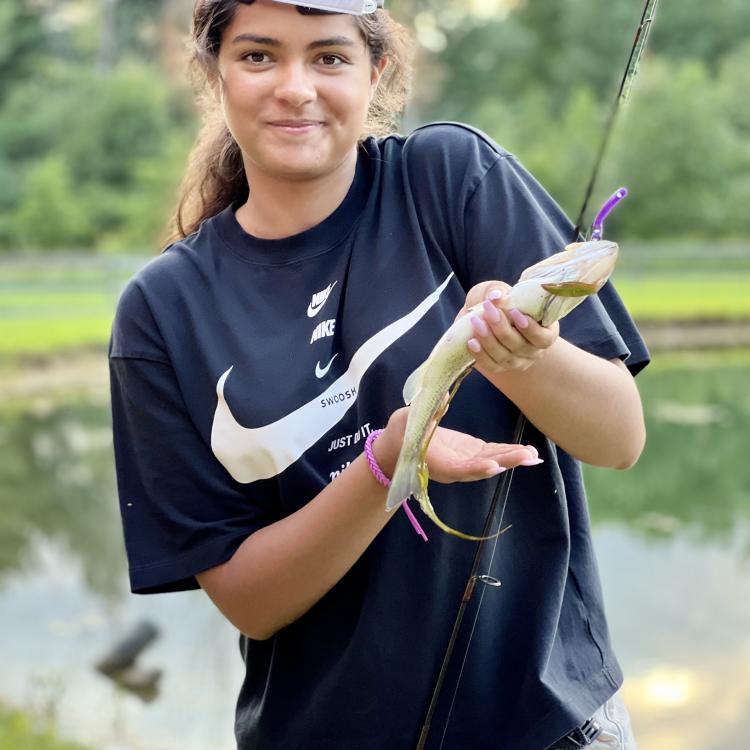 girl smiling holding fish