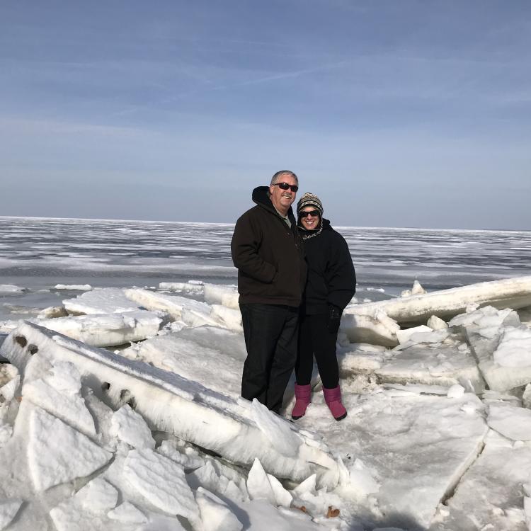 man and woman standing on ice slabs