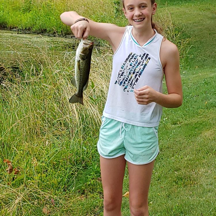 girl smiling holding fish