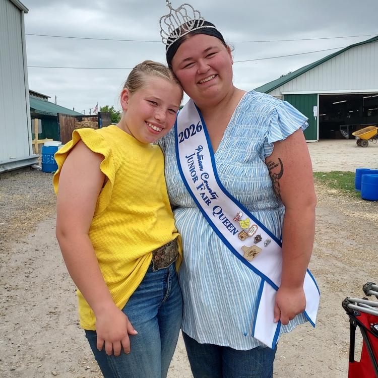 two girls, one with crown and sash