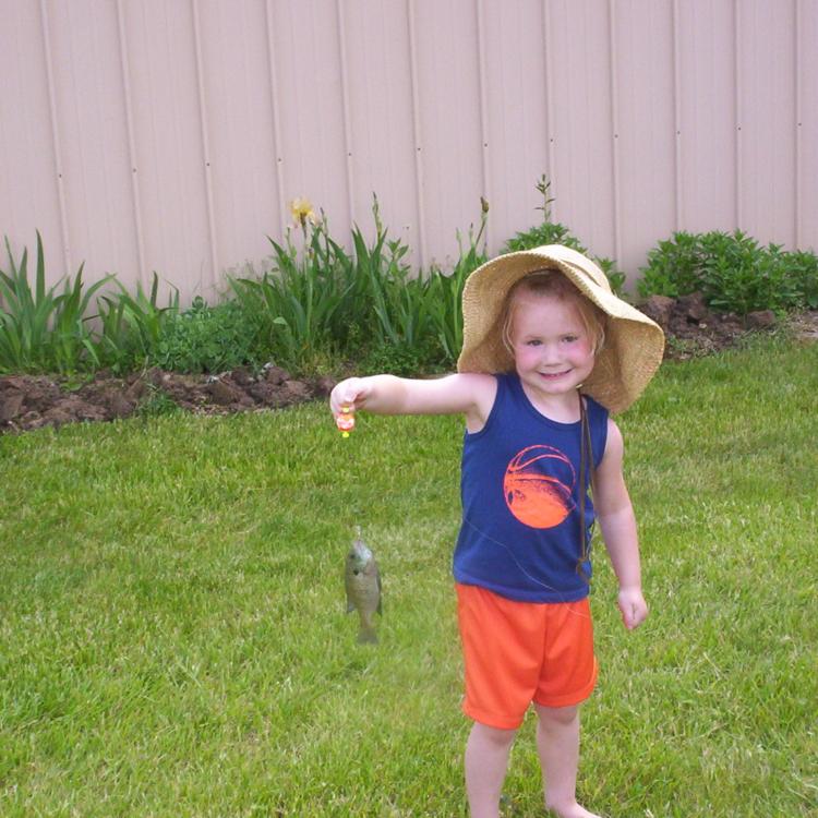 girl smiling holding a fish