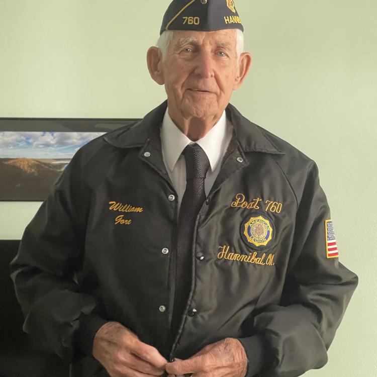 man in American Legion jacket and hat