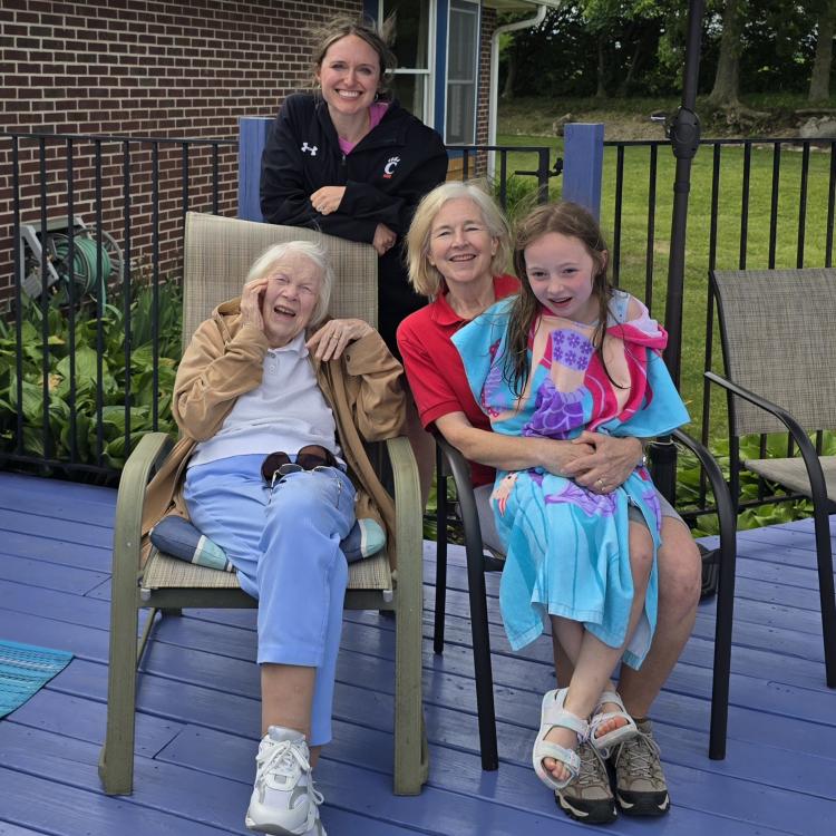 three women and a little girl on a deck