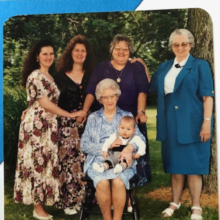 five women and a baby outdoors