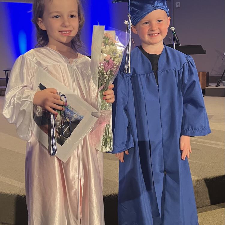 little girl and little boy in graduation gowns