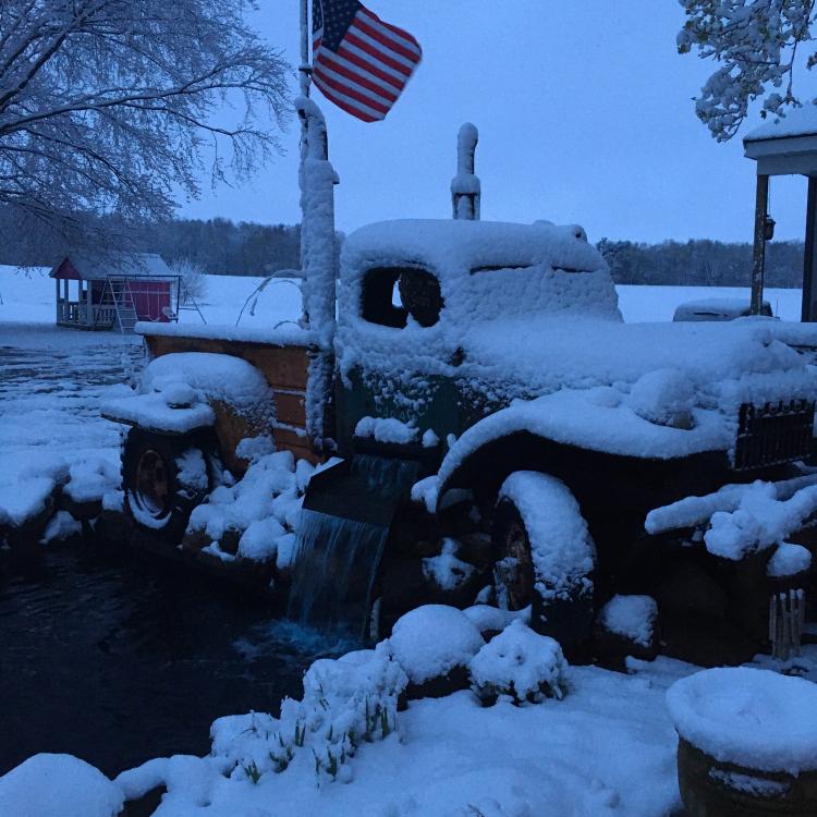 old-fashioned pickup truck covered in snow