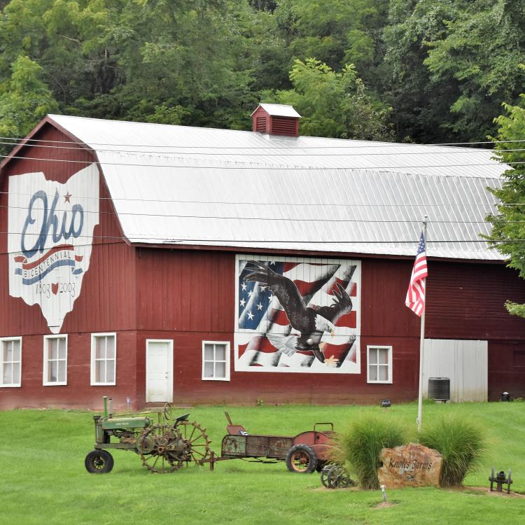 Large red barn with outline of Ohio and mural of an eagle