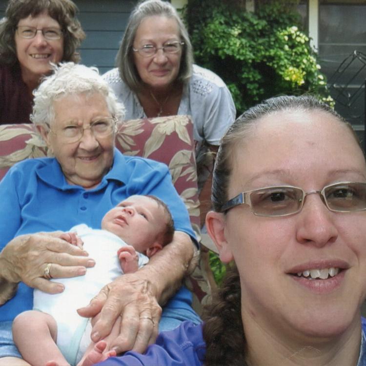 four women and a small baby outdoors