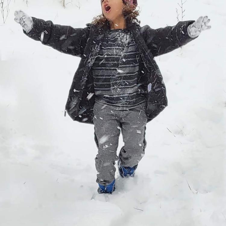 boy walking in snow