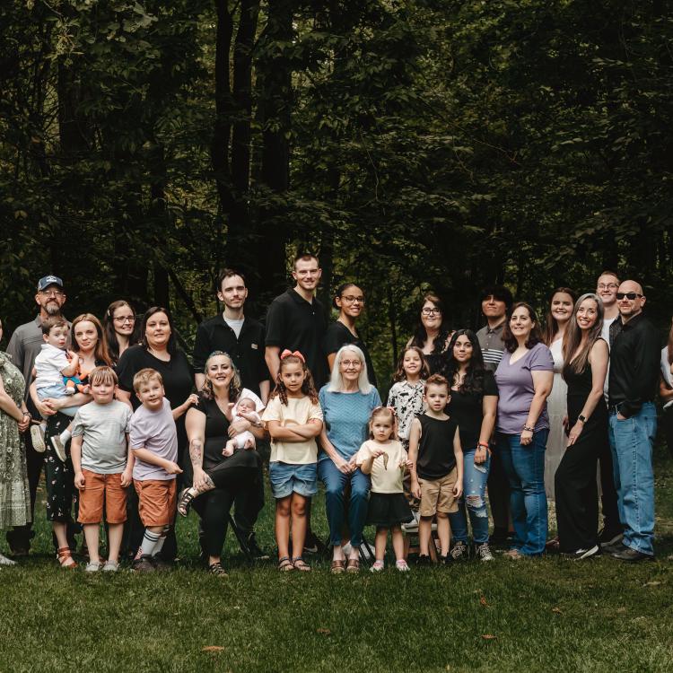 large family group lined up outdoors