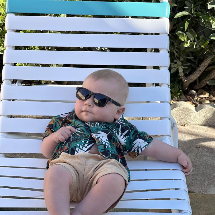 baby in sunglasses on lounge chair