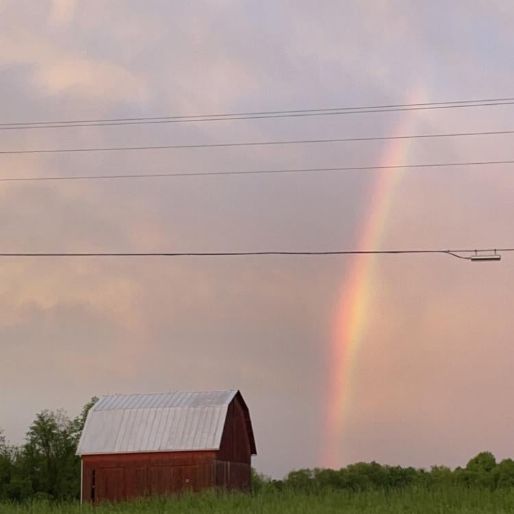 Red barn with rainbow in background