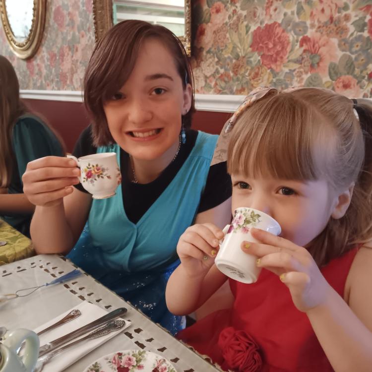 two girls drinking tea