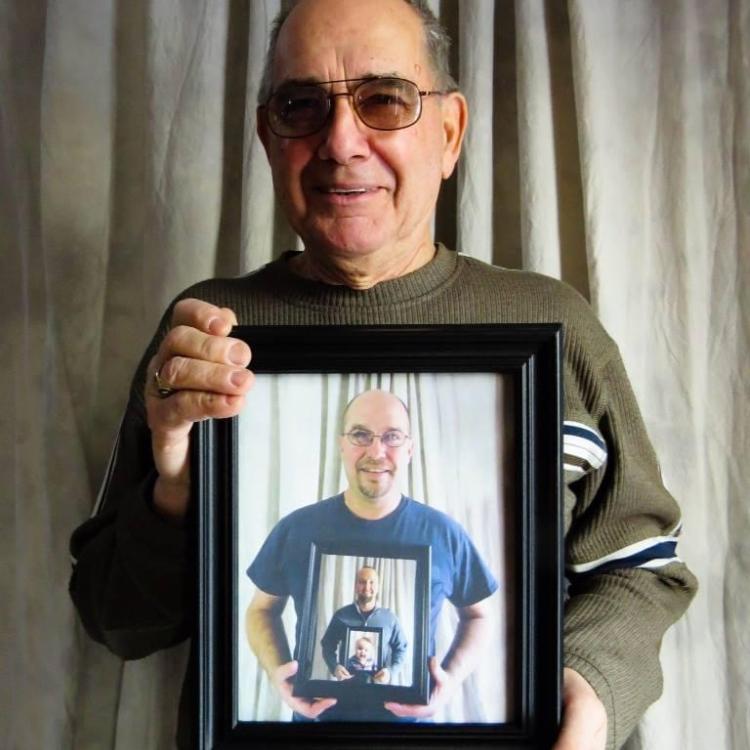 man holding photo of man holding photo, etc.