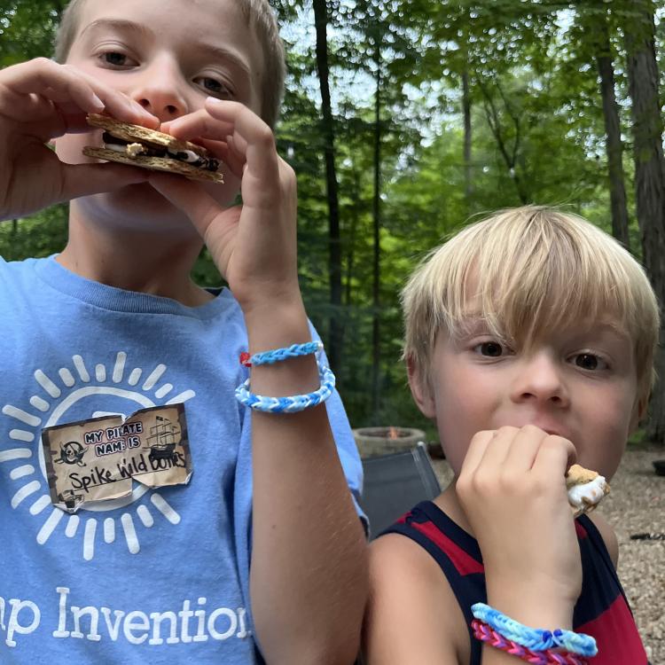 two boys eating s'mores