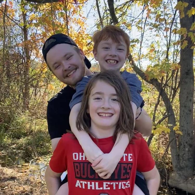 three boys in autumn forest