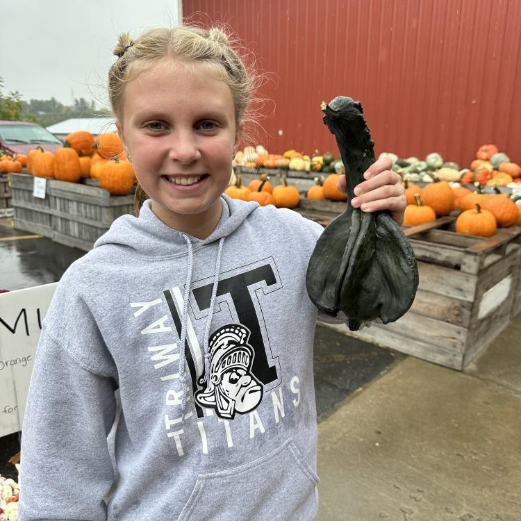 girl holding a green gourd