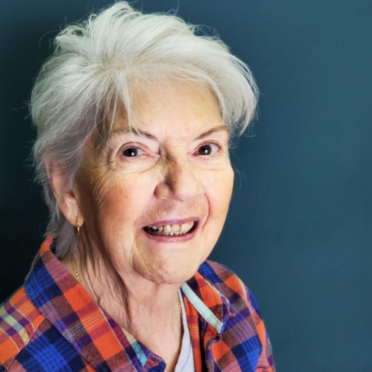 smiling woman in plaid shirt