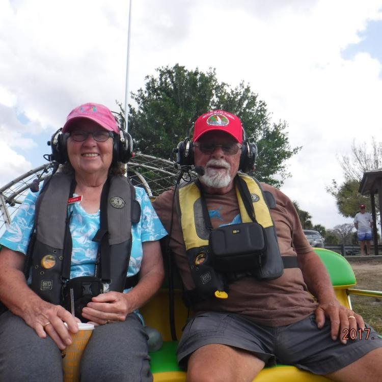 man and woman on airboat