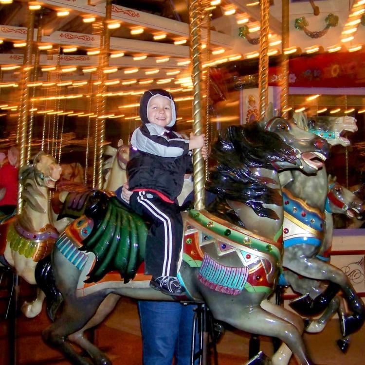 boy on carousel horse