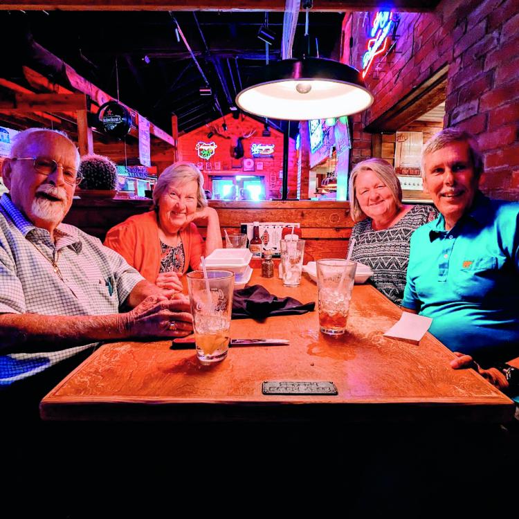 two couples at restaurant table