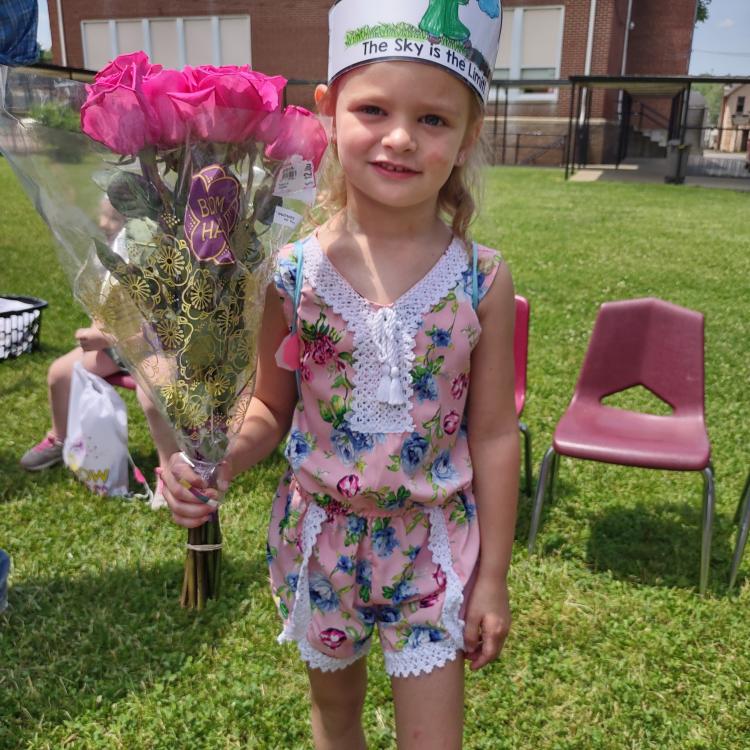 little girl holding flowers
