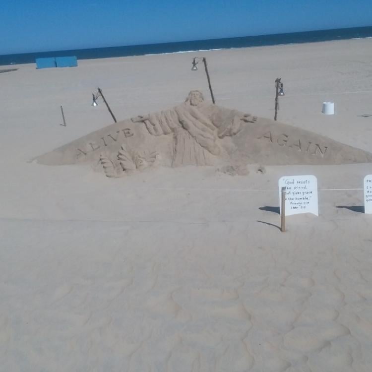 large sandcastle roped off on beach