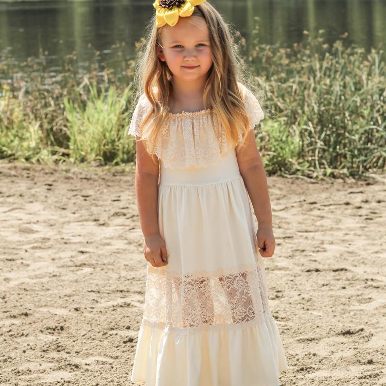 little girl with flower in her hair on beach