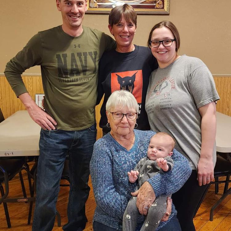 several generations of family pose indoors