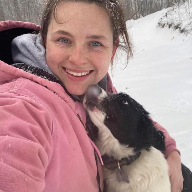 young woman and dog in snow