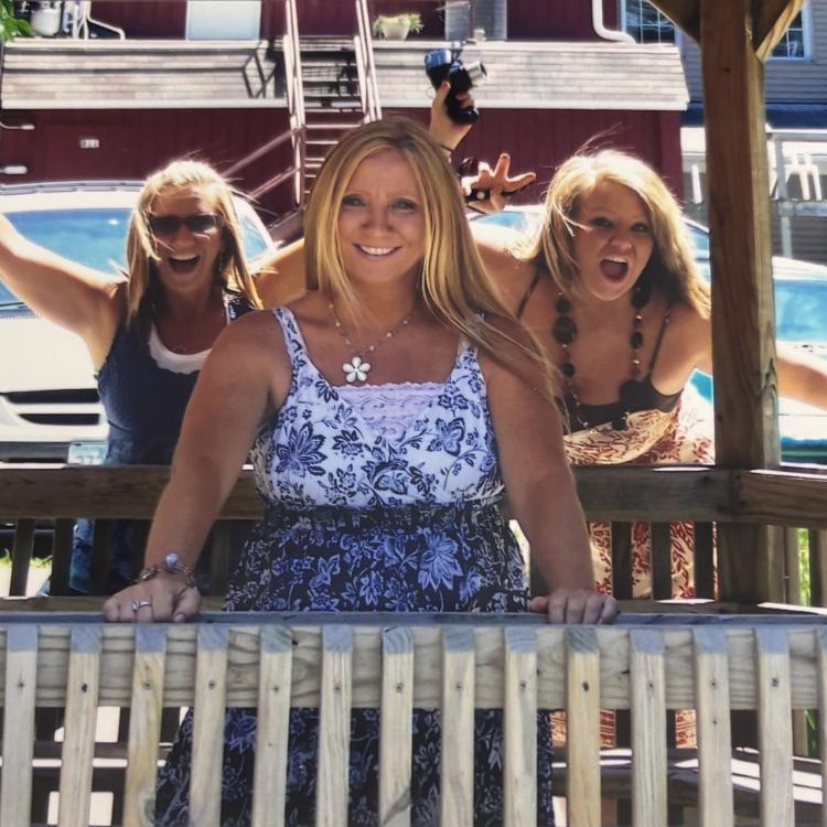 woman photobombed by two women behind
