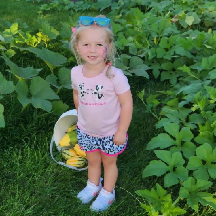 little girl with basket of gourds