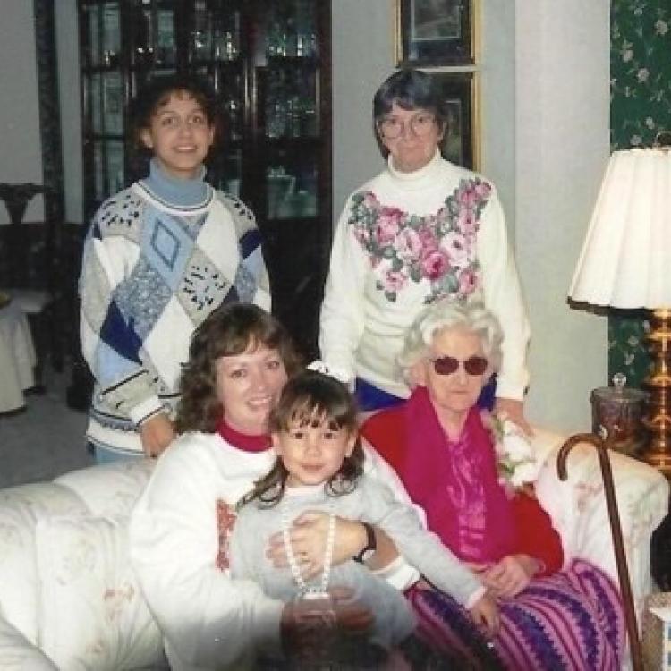 four women and a girl in a living room