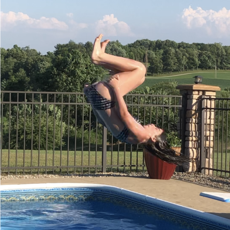 girl does a flip off diving board