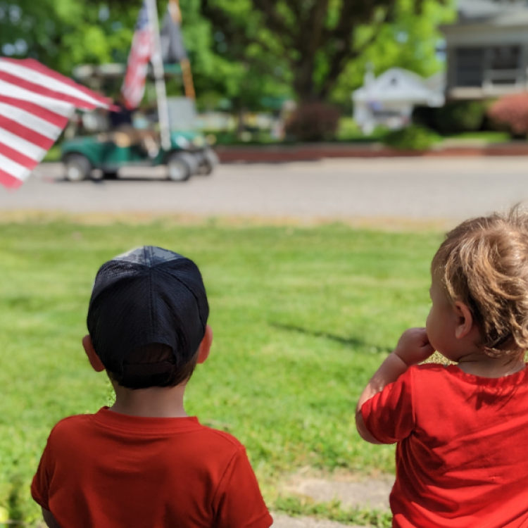 two little boys watching a parade